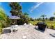 The backyard has seating, a grill, and tropical landscaping at 279 Mariner Ln, Rotonda West, FL 33947