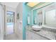 Bright bathroom featuring a granite countertop, a vessel sink, and an adjacent pool patio at 279 Mariner Ln, Rotonda West, FL 33947