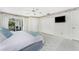 Serene bedroom featuring white bedding, tile floors, and sliding doors to an outdoor patio at 279 Mariner Ln, Rotonda West, FL 33947