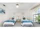 Bright bedroom with twin beds, white furniture, tile flooring, and ceiling fan at 279 Mariner Ln, Rotonda West, FL 33947