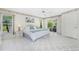 Bright bedroom with a king-size bed, tile floors, and sliding glass doors to the patio at 279 Mariner Ln, Rotonda West, FL 33947
