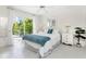 Cozy bedroom with white tile floors, and sliding glass door to patio at 279 Mariner Ln, Rotonda West, FL 33947