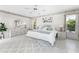 Light-filled bedroom with tile flooring, stylish decor, and a comfortable king-size bed at 279 Mariner Ln, Rotonda West, FL 33947