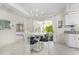 Cozy dining area with white table and chairs, chandelier, and view of the outdoor patio at 279 Mariner Ln, Rotonda West, FL 33947