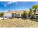 This home's exterior shows tidy landscaping and a two-car garage at 279 Mariner Ln, Rotonda West, FL 33947