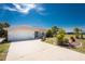 This home's exterior shows tidy landscaping and a two-car garage at 279 Mariner Ln, Rotonda West, FL 33947