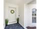 Front door view of home featuring front door decor, potted plants and an arched window at 279 Mariner Ln, Rotonda West, FL 33947