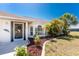 Front exterior view of home featuring tropical landscaping and decorative entry door at 279 Mariner Ln, Rotonda West, FL 33947