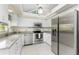 Modern kitchen with stainless steel appliances, granite countertops, and bright white cabinetry at 279 Mariner Ln, Rotonda West, FL 33947