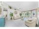 Bright living room with white tile floors, vaulted ceilings, large windows, and stylish decor at 279 Mariner Ln, Rotonda West, FL 33947