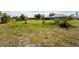 View of an empty, grassy lot ready for a new house to be built on at 279 Mariner Ln, Rotonda West, FL 33947