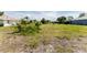 View of an empty, grassy lot ready for a new house to be built on at 279 Mariner Ln, Rotonda West, FL 33947
