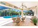 Beautiful screened lanai featuring stylish wicker seating and a view of the inviting pool at 279 Mariner Ln, Rotonda West, FL 33947