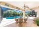 Inviting outdoor patio with wicker seating and a view of the sparkling pool, perfect for entertaining at 279 Mariner Ln, Rotonda West, FL 33947