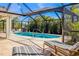Private screened-in pool with lounging chairs for enjoying sunny days in a tropical backyard oasis at 279 Mariner Ln, Rotonda West, FL 33947