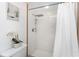 Elegant shower featuring white tiling, a rainfall shower head, and modern fixtures at 279 Mariner Ln, Rotonda West, FL 33947