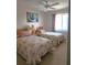 This cozy bedroom features two twin beds, a ceiling fan, and bright natural light from the window at 4056 Oakview Dr # E10, Port Charlotte, FL 33980