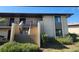 Attractive condo building featuring neutral stucco, dark trim, and well-maintained landscaping at 4056 Oakview Dr # E10, Port Charlotte, FL 33980