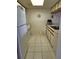 This is a galley kitchen featuring white appliances, neutral cabinets, and tile flooring, offering a clean and functional space at 4056 Oakview Dr # E10, Port Charlotte, FL 33980