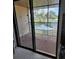 A cozy screened-in patio with a table and chairs overlooks a serene lake, inviting relaxation and outdoor enjoyment at 4056 Oakview Dr # E10, Port Charlotte, FL 33980