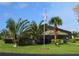 Community pool with screened enclosure, lush landscaping, and plenty of seating at 4056 Oakview Dr # E10, Port Charlotte, FL 33980