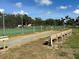 Well-maintained bocce court next to tennis court with benches and manicured lawn at 4056 Oakview Dr # E10, Port Charlotte, FL 33980