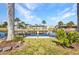 Picturesque backyard canal view with a private dock, waterfront access, and lush tropical landscaping at 4231 Hollis Ave, Port Charlotte, FL 33953