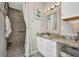 Renovated bathroom with granite countertop, walk-in shower, and modern fixtures at 4231 Hollis Ave, Port Charlotte, FL 33953