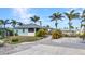 Single Gathering home with tropical landscaping, a front patio and concrete driveway at 4231 Hollis Ave, Port Charlotte, FL 33953