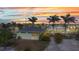 Home with lush, tropical landscaping at sunset at 4231 Hollis Ave, Port Charlotte, FL 33953