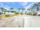 Charming single-story home featuring well-maintained landscaping, an expansive driveway, and a quaint facade at 4231 Hollis Ave, Port Charlotte, FL 33953