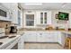 Modern kitchen with white cabinets, granite countertops, stainless steel appliances, and a window for natural light at 4231 Hollis Ave, Port Charlotte, FL 33953