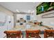 Well-lit kitchen features granite countertops, white cabinets, and a kitchen island with bar seating at 4231 Hollis Ave, Port Charlotte, FL 33953