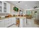 Bright kitchen with a large island, granite countertops, white cabinets, and an open floorplan into the living area at 4231 Hollis Ave, Port Charlotte, FL 33953
