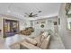 Bright living area features tile floors, comfortable seating, and sliding door access to outdoor space at 4231 Hollis Ave, Port Charlotte, FL 33953
