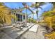 Charming patio area with a wooden pergola, picnic table, and a barbecue grill for outdoor enjoyment at 4231 Hollis Ave, Port Charlotte, FL 33953