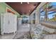 Cozy sunroom features a small refrigerator, daybed and seating for 4 at 4231 Hollis Ave, Port Charlotte, FL 33953