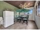 Bright sunroom with tile floor, mini fridge and seating at 4231 Hollis Ave, Port Charlotte, FL 33953