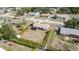 Aerial view of a home with enclosed porch and an expansive backyard featuring palm trees at 4282 Pocatella Ave, North Port, FL 34287