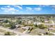 Expansive aerial view of a neighborhood featuring single-Gathering homes and a scenic lake under a partly cloudy sky at 4282 Pocatella Ave, North Port, FL 34287
