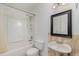 Bathroom with a bathtub-shower combo and vanity with traditional fixtures at 4282 Pocatella Ave, North Port, FL 34287