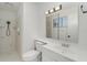 Bright white bathroom featuring shower, modern vanity, and ample lighting at 4282 Pocatella Ave, North Port, FL 34287
