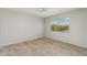 Bright bedroom with tan tile flooring, ceiling fan, and sunny window at 4282 Pocatella Ave, North Port, FL 34287