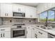 Stylish kitchen with stainless steel appliances, granite countertops, and modern backsplash at 4282 Pocatella Ave, North Port, FL 34287