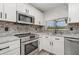 Modern kitchen with stainless steel appliances and a sleek backsplash at 4282 Pocatella Ave, North Port, FL 34287