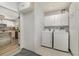 Functional laundry room with washer, dryer, and storage cabinets, conveniently located near kitchen at 4282 Pocatella Ave, North Port, FL 34287