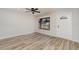 Bright living room with wood-look tile floors, a ceiling fan, and ample natural light at 4282 Pocatella Ave, North Port, FL 34287