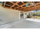 Spacious covered patio with exposed wooden beams and concrete flooring at 4282 Pocatella Ave, North Port, FL 34287