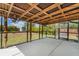 Screened patio area with concrete flooring, tropical decor, and large yard beyond at 4282 Pocatella Ave, North Port, FL 34287