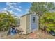 Outdoor shed with door, window, and overgrown foliage at 4282 Pocatella Ave, North Port, FL 34287